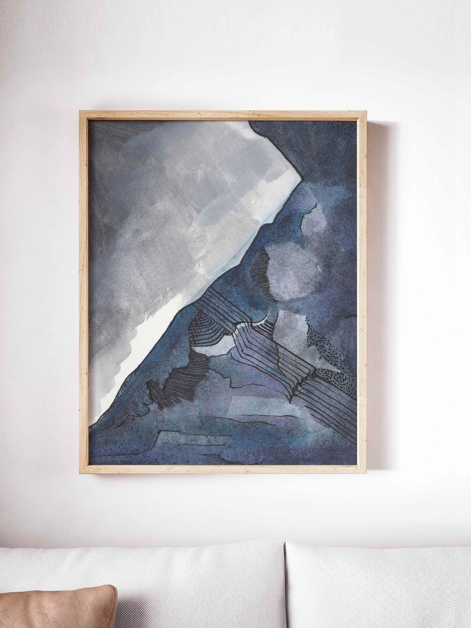 Abstract Blue and Gray Watercolor framed on a white wall.